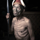 Manchak Wankongpa, 80, wears a hat decorated with two tusks of a wild boar.